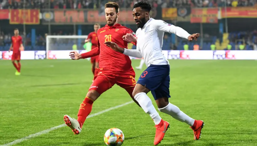 Danny Rose of England takes on Mirko Ivanic of Montenegro